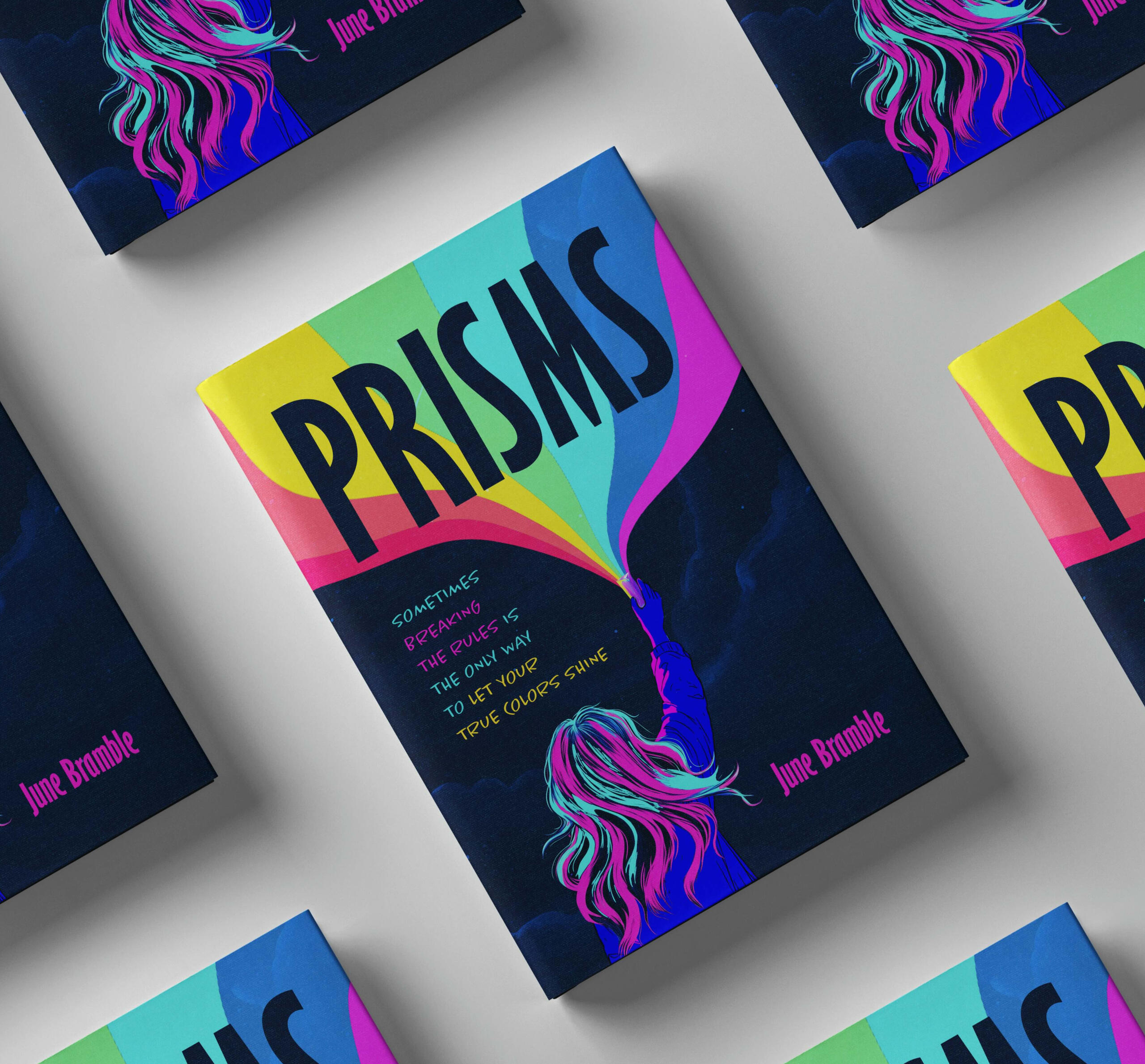 Physical Copies of Prisms Physical copies of the book Prisms by June Bramble. One copy is in the centre, and the other copies surrounding it are partially visible. On the cover, a kid with pink and blue hair holds a prism high above her, and a large rainbow shines from it.